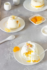 Cottage cheese dessert with apricot filling decorated with whipped cream. 