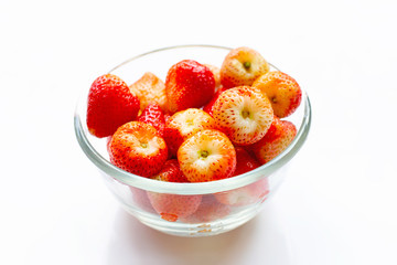 Strawberries in glass bowl isolated on white