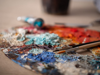 Artist's studio - closeup detail of a colourful palette with paint on