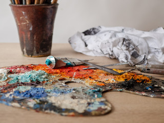 Artist's studio - closeup detail of a colourful palette with paint on