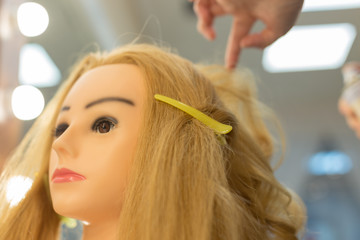 Training hairstyles on a mannequin