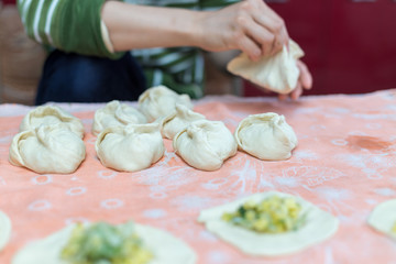 Woman cooks delicious pies (samsa)