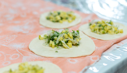 Woman cooks delicious pies (samsa) © donikz