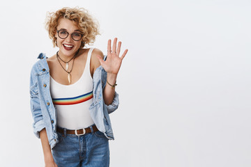 Five stars to your product. Indoor shot of enthusiastic stylish female blonde with glasses and...