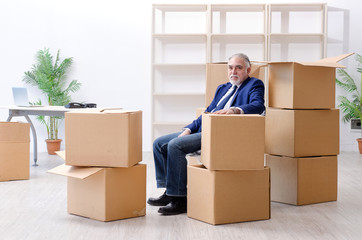 Aged businessman moving to new workplace 