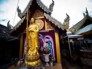 Fototapeta na wymiar Golden Chinese Monk Statue Standing in Thai Temple