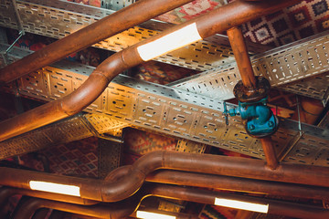 Ceiling in old warehouse with wheel and old wood beam. © Евгений Вершинин