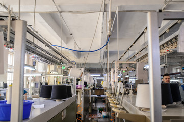 close up photo of black threads in cones on the knitting machines