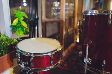 Naklejka na ściany i meble Drums conceptual image. Picture of drums and drumsticks lying on snare drum. Retro vintage instagram picture.
