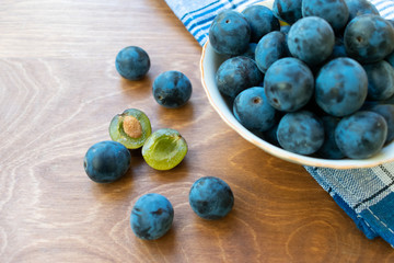 Bowl full of blackthorn on the wooden table