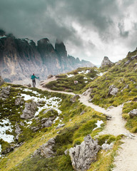 A hiker on a trail in the Dolomites of Northern Italy