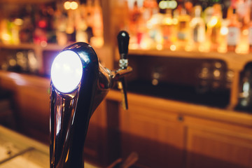 beer tap pours draught lager beer serving in a restaurant or pub.
