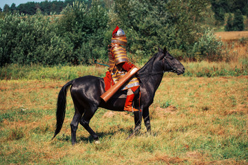 An ancient equestrian in historical costume is reconstructed