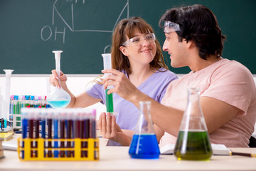 Two chemists students in classroom 