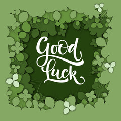 Good Luck calligraphy logo on green paper cut clover background