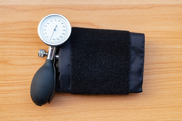 sphygmomanometer on wooden texture background