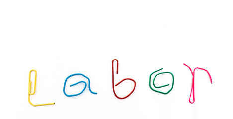 paper clip bend to the word labor to celebrate labor day in May. with light associate with the...