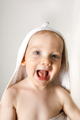 Funny baby boy in towel.