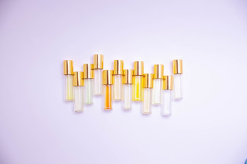 perfume glass tester vials of different kinds on light background. Perfume  sample.