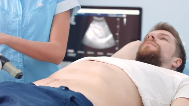 Positioning ultrasound transducer - kidney lithotripsy procedure