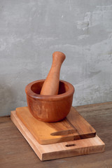 Kitchen tools for cooking on a wooden table on the background of a concrete wall. Copy space