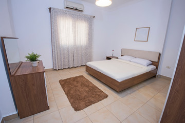 Fototapeta na wymiar Double bed in a bedroom interior design