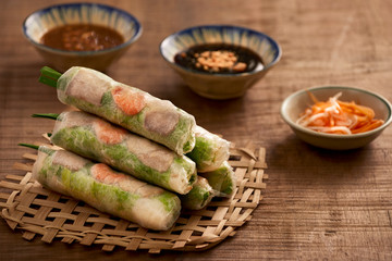 Vietnamese spring rolls - rice paper, lettuce, salad, vermicelli, noodles, shrimps, fish sauce, sweet chili, soy, lemon, veletables. Copy space. Asian and Vietnam food. Traditional national cuisine