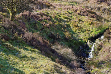 Springtime view of a waterfall in the mountains of Snowdonia.