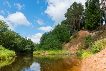 Fototapeta premium High sandy bank of the Polomet River, Novgorod Region, Russia