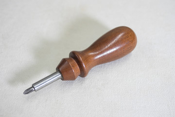 screwdriver with wooden handle on white background, copy space