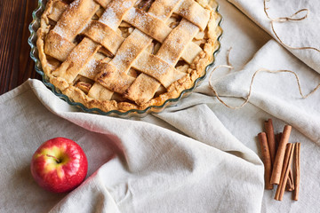 american apple pie and ingredients on wooden background. Top view.
