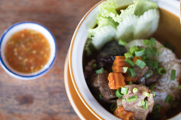 Pork spare ribs served with rice on a plate.