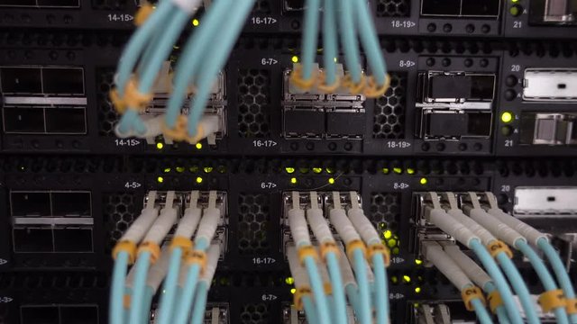Telecommunication Broadband Fiber Optical Cables. Datacenter rack. Blink Green Led Lights.
