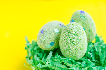 Easter background with eggs on yellow. Easter eggs