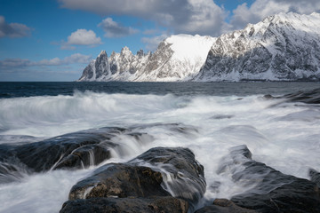 Okneset and Ersfjord from Tungeneset on a stormy day with breaking waves and spray. Sunny day in Mountains And Fjords, Winter Landscape, Norway Beautiful christmas time near Troms county. 