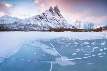 Beautiful landscape scene with Signaldalelva river and Otertinden mountain in background in Northern Norway . Sunset or sunrise in Mountains And Fjords, Winter Landscape.