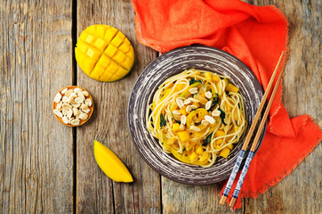 Mango pepper peanut pasta with fresh mango slices