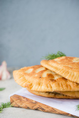 Homemade chebureks with potatoes. Of diet food. Pies with potatoes and mushrooms.