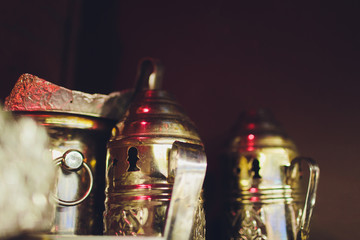Red-hot coals for hookah against the background of group of friends. Conception is recreation on...
