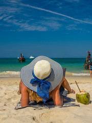 Woman enjoying her holidays on a transat at the tropical beach