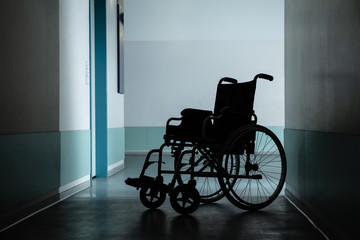 Empty Wheel Chair In Hospital Corridor