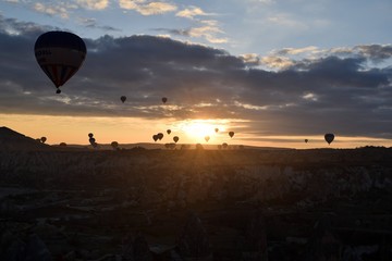Sunrise and balloons. Beautiful background of the balloon and the sunset.Cappadocia. Turkey. Göreme. Nevşehir. Türkiye. 8. 04. 2019. Balloons flying over the rocky landscape in Cappadocia Turkey. 