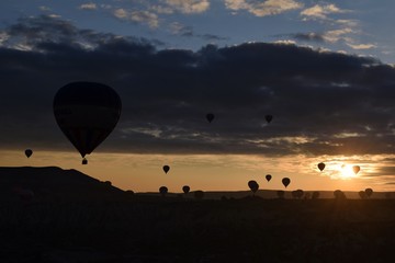 Sunrise and balloons. Beautiful background of the balloon and the sunset.Cappadocia. Turkey. Göreme. Nevşehir. Türkiye. 8. 04. 2019. Balloons flying over the rocky landscape in Cappadocia Turkey. 