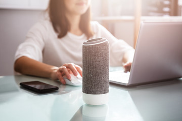 Woman Using Voice Assistant In Office