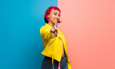 Young woman with yellow jacket showing and lifting a finger