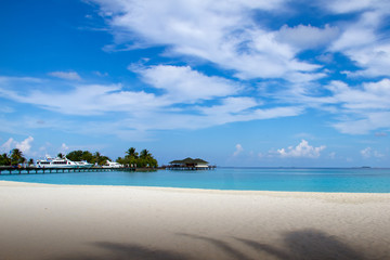 Tropical Beach in Maldives with Blue Sky and Clouds