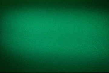 Blurred textural cloud of green color on a dark green background