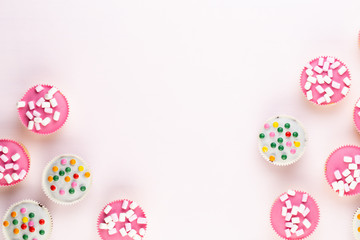 Fototapeta na wymiar Colorful cupcakes on a white background.