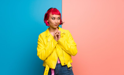 Young woman with yellow jacket scheming something