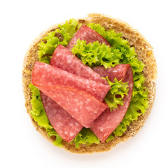 Sandwich with salami sausage on white background.